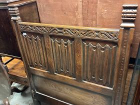 Early 20th century carved oak single bedstead with linen fold panels
