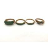 Four 9ct gold emerald/ green stone dress rings