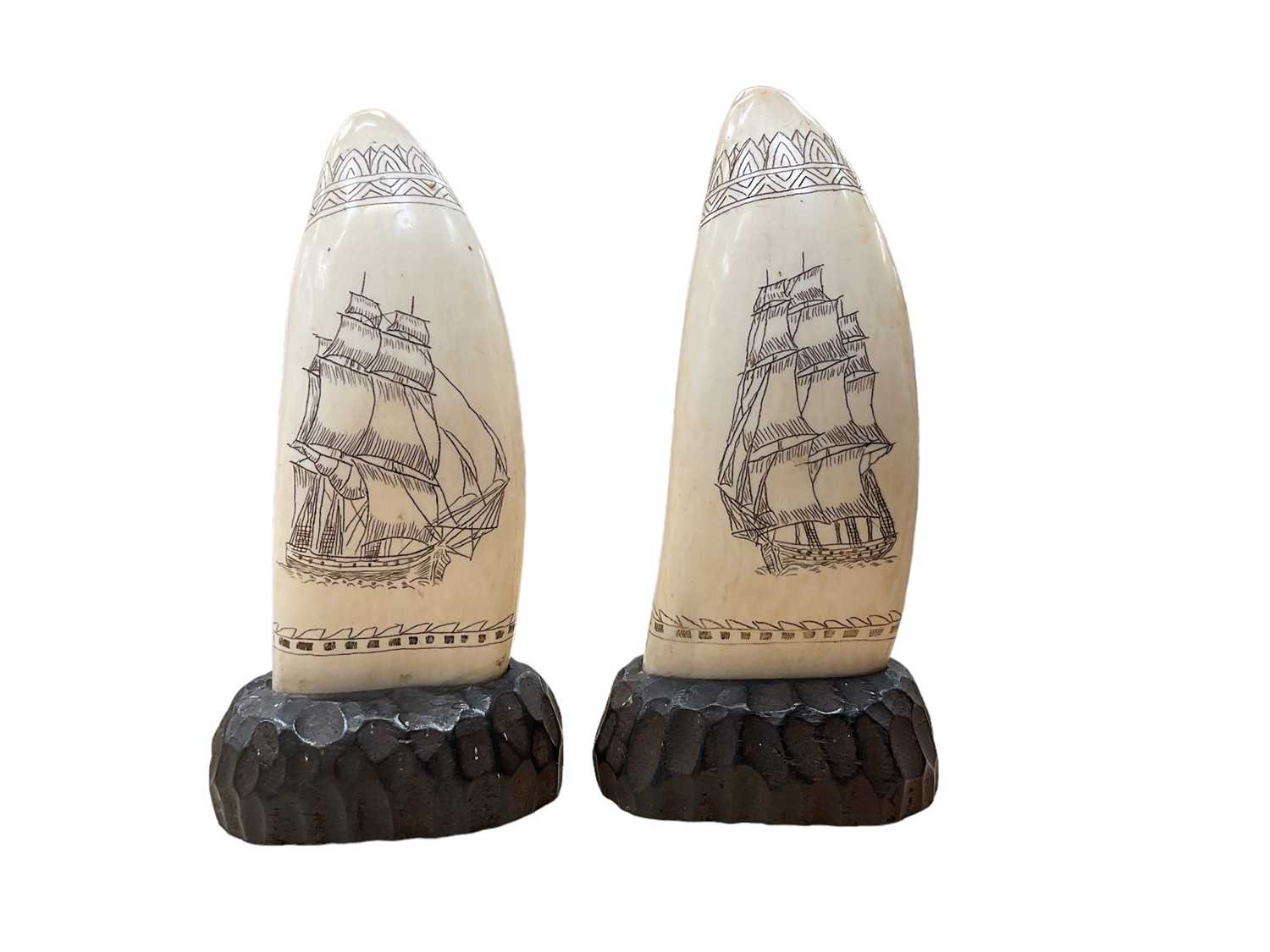 Pair of scrimshaw whale's teeth mounted on wooden bases, 19th century style but later - Image 2 of 2