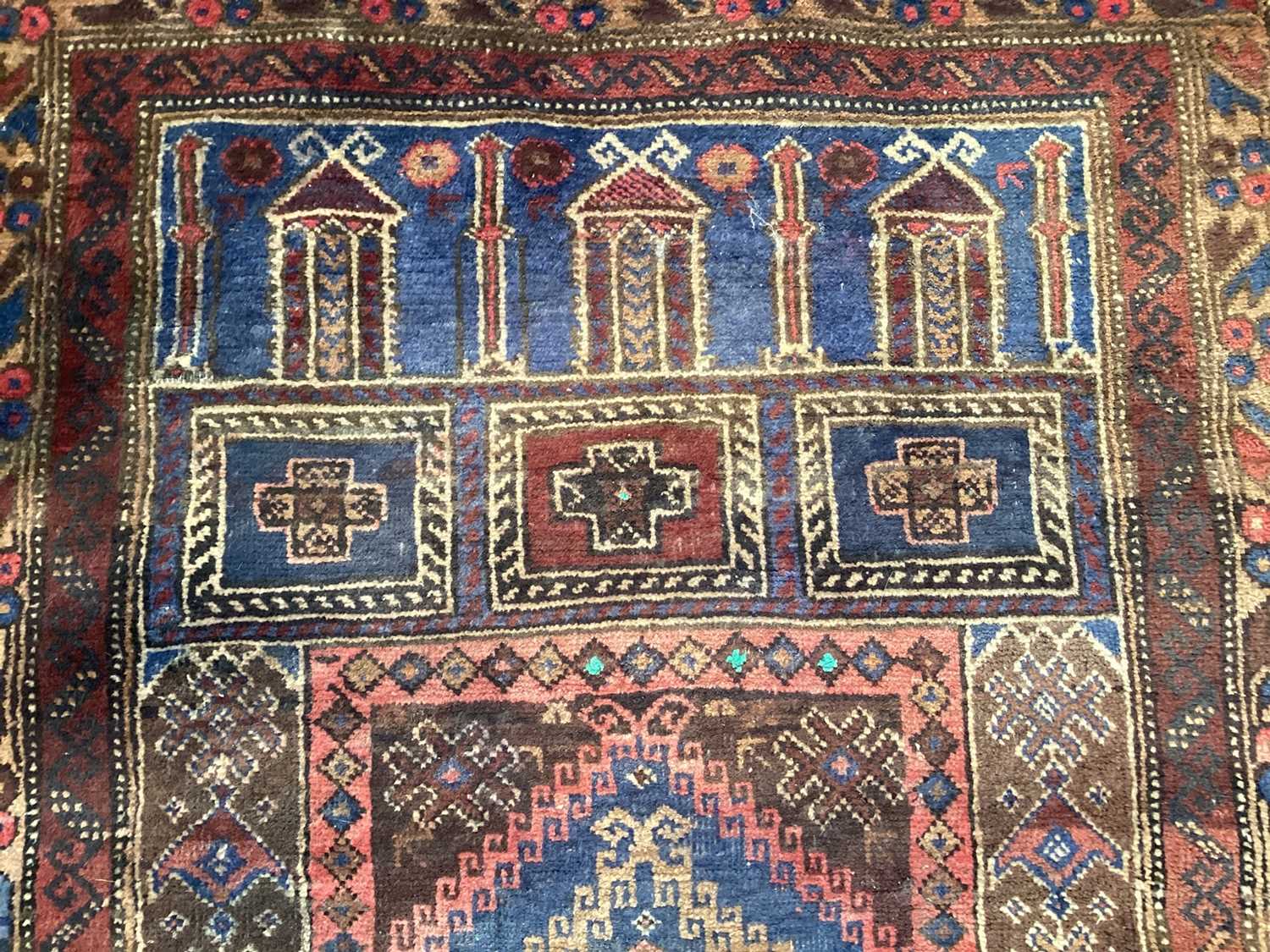 Eastern rug decorated with buildings on red, blue and brown ground, 128cm x 80cm - Image 3 of 4