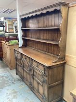 Good quality oak two height dresser with carved decoration
