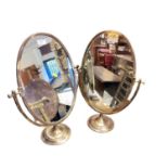 Pair of brass framed oval swing mirrors