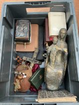 Collection of religious books, rosary beads, religious figure and related items.