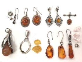 Small group of silver and white metal mounted amber earrings and pendants