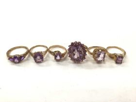 Six 9ct gold purple gem set dress rings