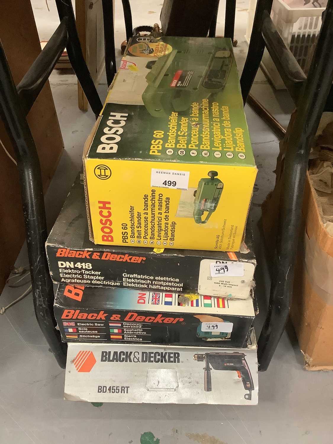 Group of various power tools to include belt sander, circular saw and drill.