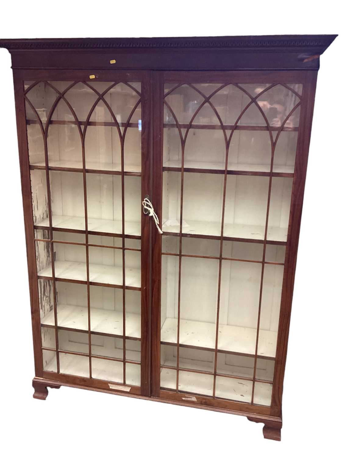 Large mahogany display cabinet enclosed by two glazed doors.