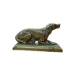 19th century brass fairing in the form of a seated spaniel, 14cm in overall length.