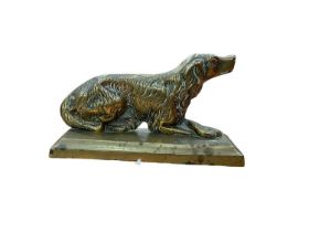 19th century brass fairing in the form of a seated spaniel, 14cm in overall length.