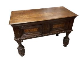 17th century and later oak cupboard enclosed by two inlaid and carved panelled doors on four carved