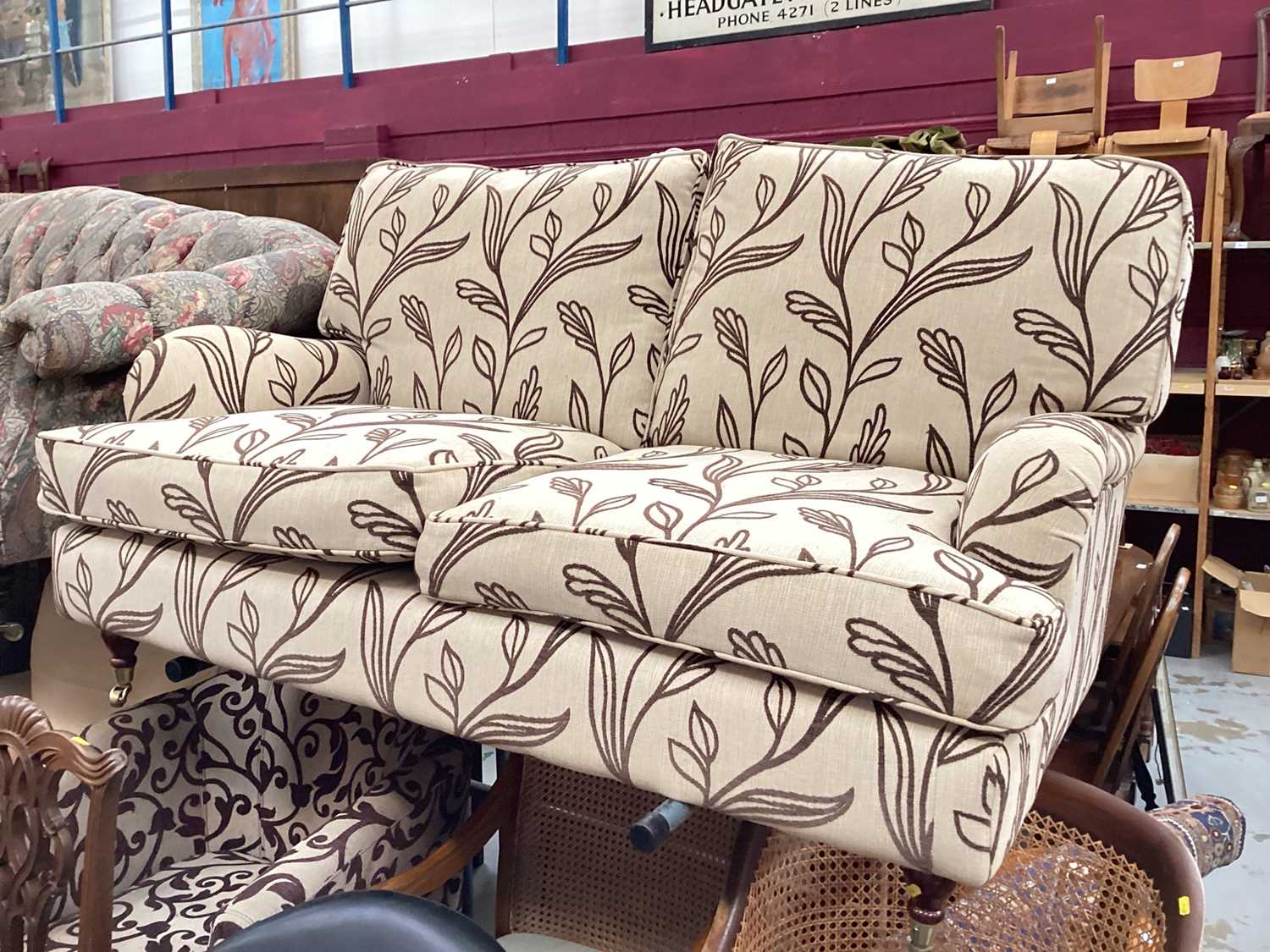 Contemporary cream two seater settee with brown leaf decoration on turned legs and brass castors, 14 - Image 4 of 9