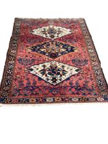 Eastern rug with three central medallions on red, blue, cream and green ground, 191cm x 148cm