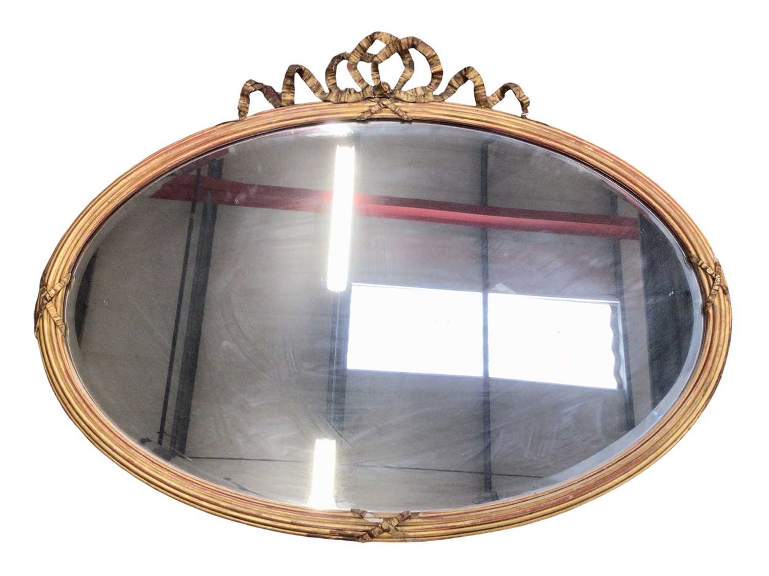 Louis XVI style oval giltwood and gesso wall mirror