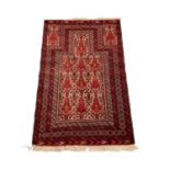 Baluch rug with geometric decoration on red ground, 144cm x 93cm