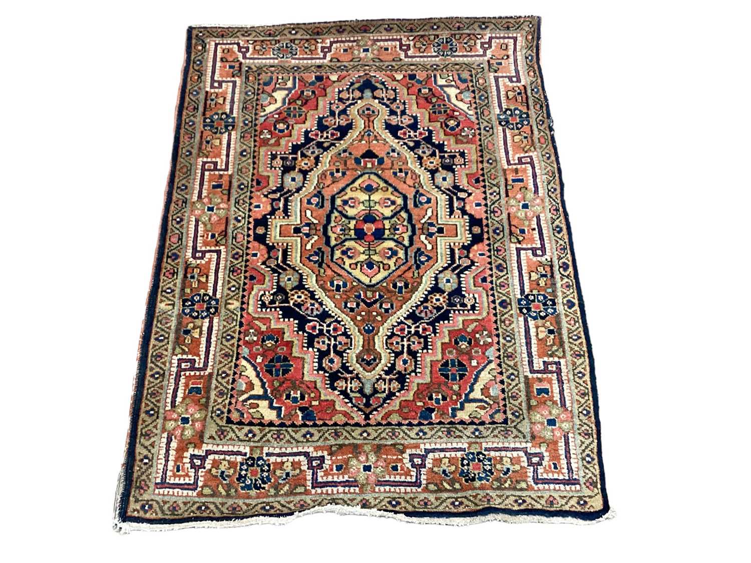 Eastern rug with geometric decoration on red, orange, blue and green ground, 97cm x 73cm