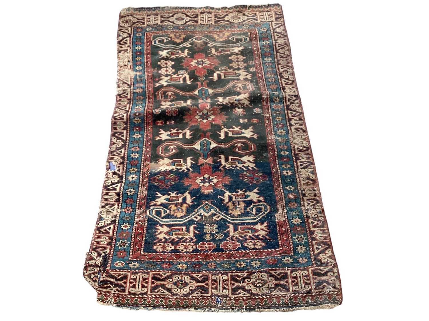 Eastern rug with geometric decoration on red, blue and black ground, 135cm x 72cm