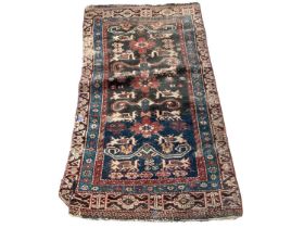 Eastern rug with geometric decoration on red, blue and black ground, 135cm x 72cm