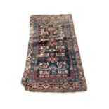 Eastern rug with geometric decoration on red, blue and black ground, 135cm x 72cm