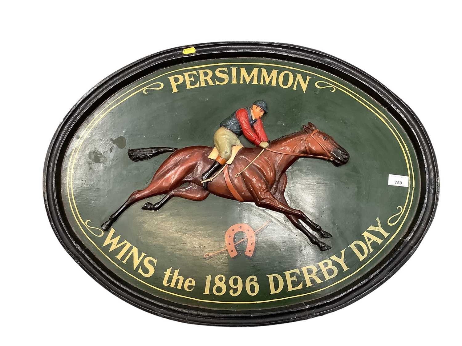 Painted woooden oval plaque depicting a jockey on a racehorse 'Persimmon wins the 1896 Derby Day'