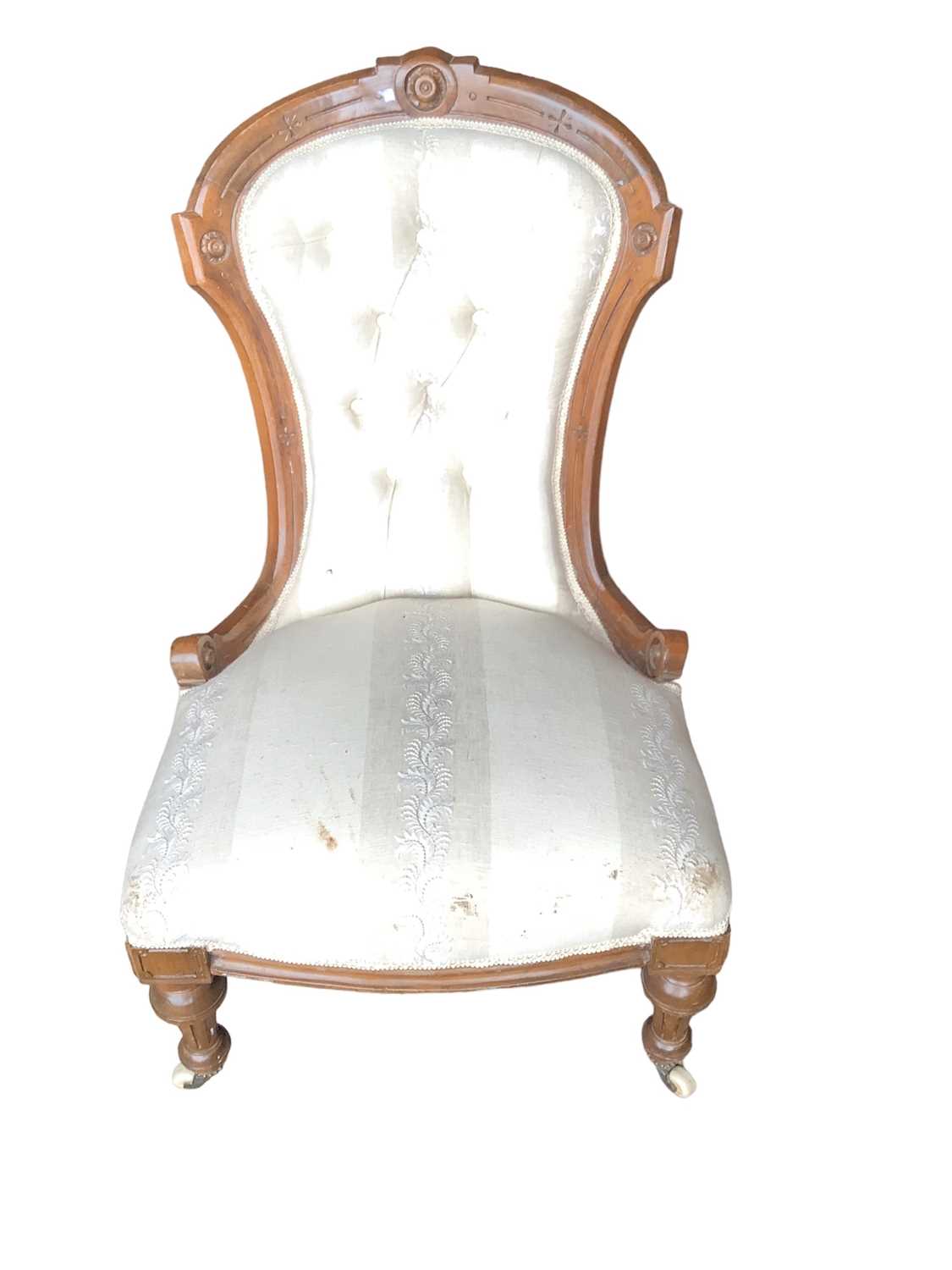 Victorian walnut framed chair with buttoned upholstery on fluted turned front legs and ceramic casto