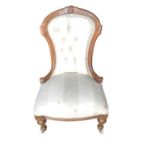 Victorian walnut framed chair with buttoned upholstery on fluted turned front legs and ceramic casto