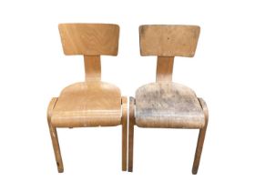Three old plywood school chairs together with two folding directors chairs