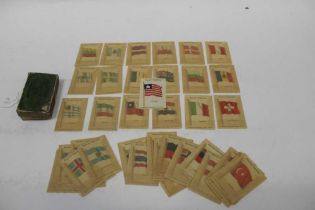 A box containing Kensitas silk flag cigarette cards