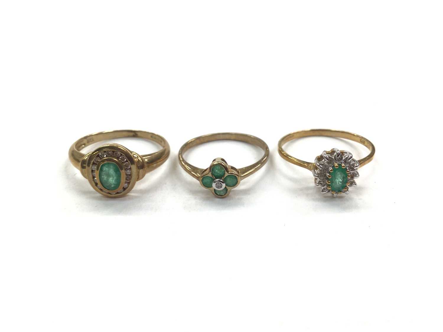 Three 9ct gold emerald and diamond set rings