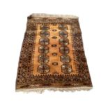 Eastern rug with twelve medallions on rust brown ground, 120cm x 89cm