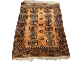 Eastern rug with twelve medallions on rust brown ground, 120cm x 89cm