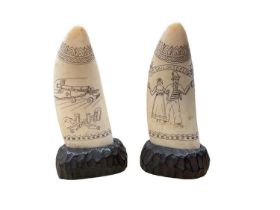 Pair of scrimshaw whale's teeth mounted on wooden bases, 19th century style but later