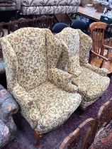 Two similar wing back armchairs with yellow floral upholstery