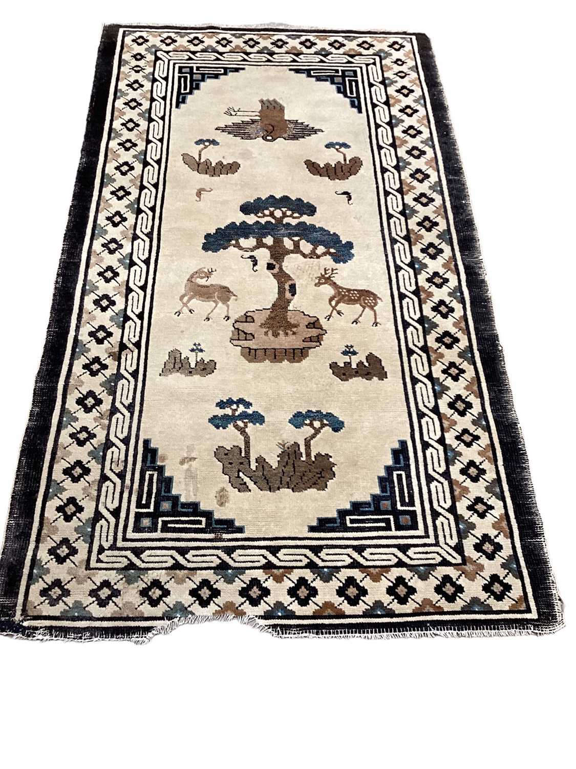 Chinese rug together with a narrow Persian rug