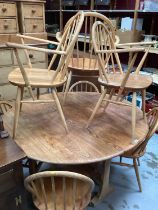 Ercol elm oval dropleaf kitchen table opening to 127 x 141cm and seven Ercol stick back chairs compr