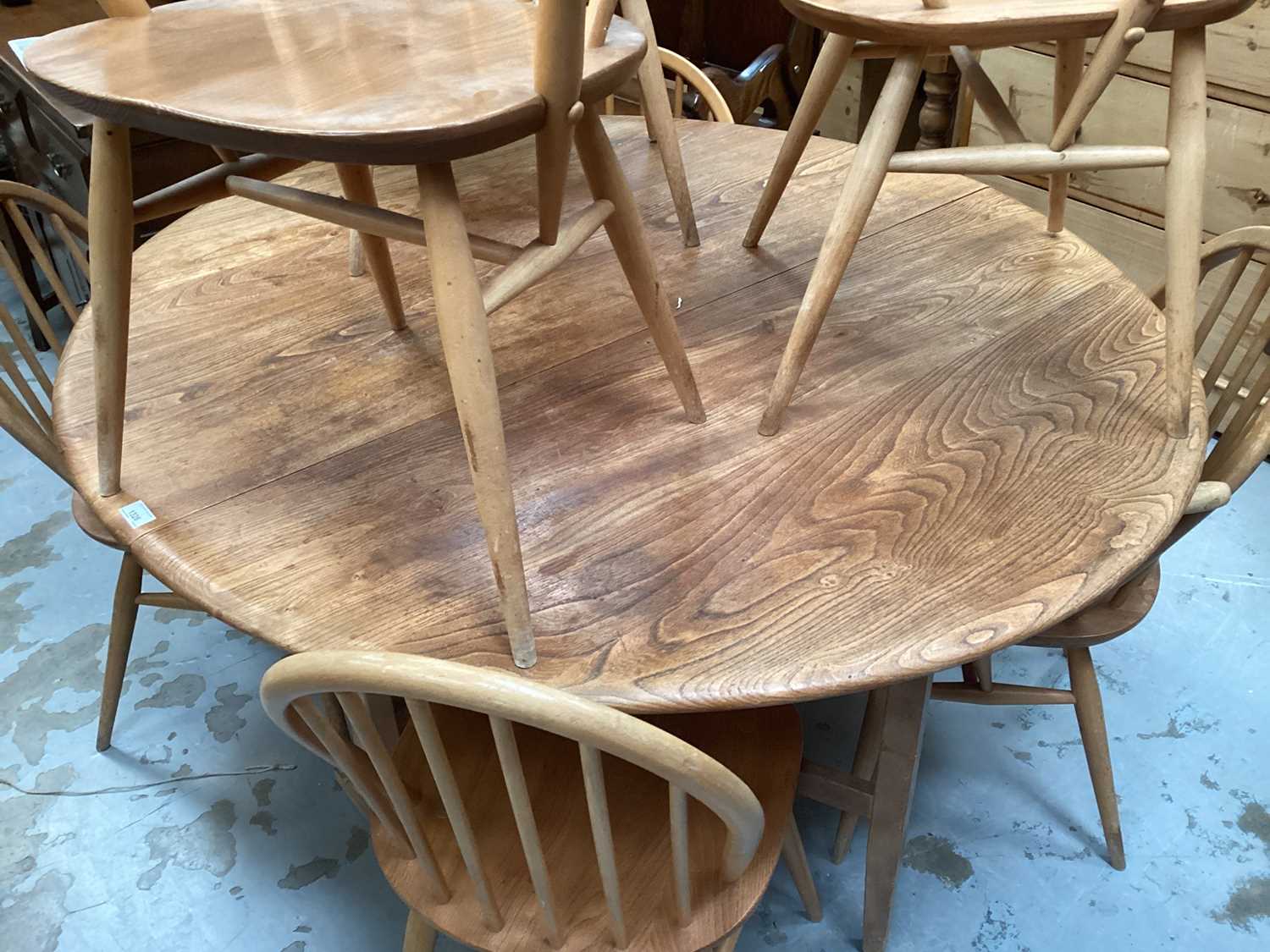 Ercol elm oval dropleaf kitchen table opening to 127 x 141cm and seven Ercol stick back chairs compr - Image 2 of 3