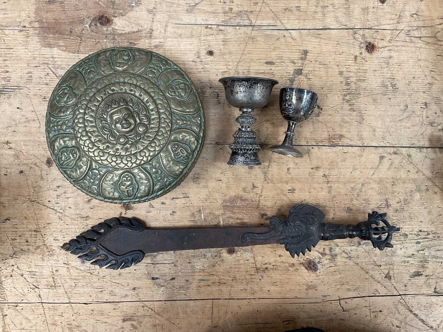 Group of Tibetan items, including two white metal wine cups, a brass relief decorated box and a Phur