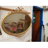 Gilt oval mirror with ribbon surmount