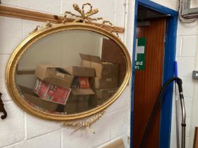 Gilt oval mirror with ribbon surmount