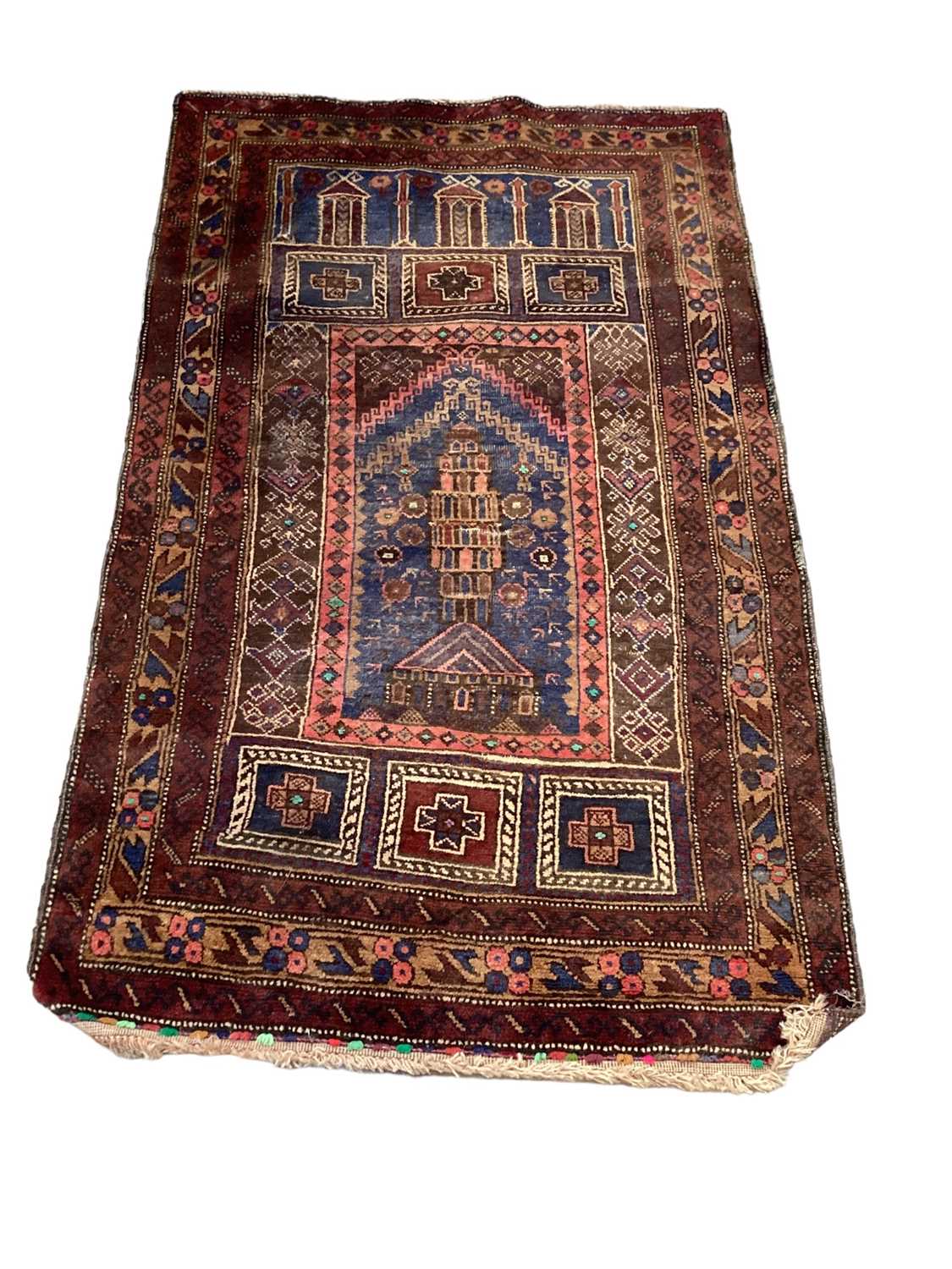 Eastern rug decorated with buildings on red, blue and brown ground, 128cm x 80cm