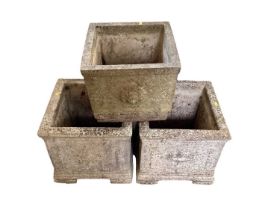 Pair of square concrete garden planters, 38cm high, together with another, 30cm high (3)