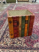 A leather waste paper bin with faux book spine front