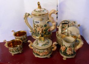 A vintage Capodimonte coffee set decorated in typical style with moulded figural scenes,