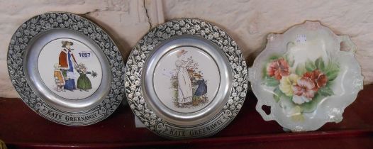 A pair of pewter mounted ceramic plates with Kate Greenaway decoration - sold with another