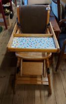 A vintage mixed wood metamorphic highchair