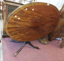 A 1.2m 19th Century mahogany and cross banded oval tilt-top loo table, set on turned pillar and