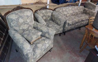 A 1920's style carved oak part show frame three piece suite, comprising a 1.96m settee and pair of