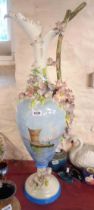 A very large Italian pottery jug of ewer form with applied flowers and hand painted decoration,