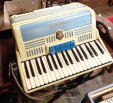 A vintage Italian Scandalli piano accordion in cream colourway with ivorine keys, in hard carry