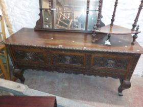 A 1.83m Victorian carved oak dresser base with lion mask handles to the three deep drawers, set on