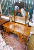 A 1.14m 1930's walnut kneehole dressing table with triple mirror over three frieze drawers and